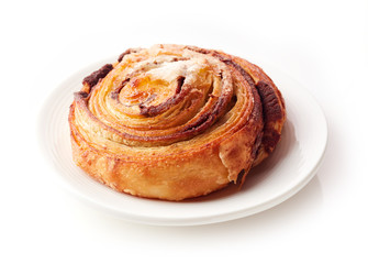 Obraz na płótnie Canvas Sweet bun with cinnamon on white plate isolated on white