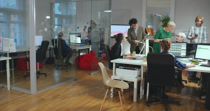 Picture of modern loft office full of working people