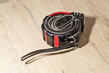 Fototapeta premium old measuring tape measure on the floor in the apartment