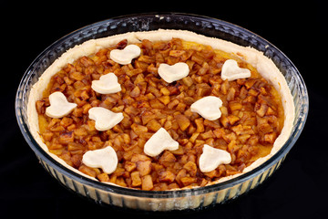 Apple pie served in glass service plate with isolated black background