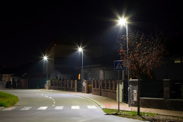 small village street with modern LED streetlights at night