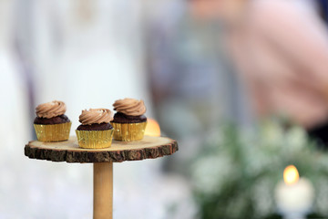 Babeczki czekoladowe na drewnianej tacy w ciastkarni.
