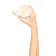 White cup mug in hand arm raised up on white background isolation