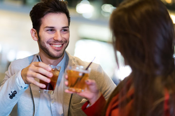Couple toasting glasses in a disco