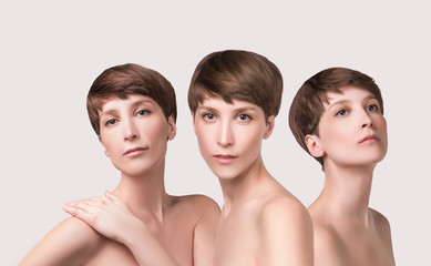 Beautiful woman. Female face close up. Portrait of young caucasian woman at studio isolated on white. Fresh skin and beauty concept. Short haircut, long neck, perfect skin