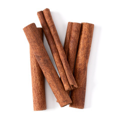 Cinnamon sticks isolated on white background closeup. Canella spice. Aromatic condiment background. Flat lay, top view.