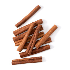 Cinnamon sticks isolated on white background closeup. Canella spice. Aromatic condiment background. Flat lay, top view.