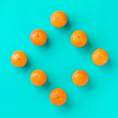 Fruit pattern of mandarin isolated on blue background. Tangerine. Flat lay, top view.