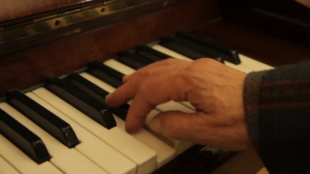 the hand of the pianist glide over the keys