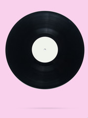 Retro style vinyl record on pink pastel background, minimalism. Photo with shadow