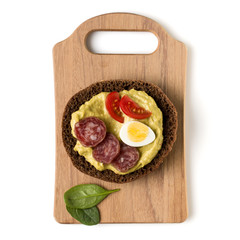 Open  faced sausage sandwich canape or crostini on a wooden serving board  isolated on white background closeup. Top view.