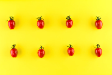 Food pattern of cherry tomato  isolated on yellow background. Flat lay, top view.