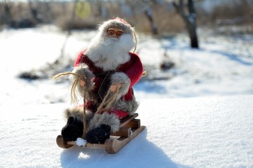 Christmas toys Santa Claus in a sleigh, in the woods, outdoors.