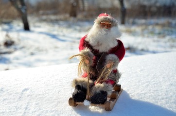 Christmas toys Santa Claus in a sleigh, in the woods, outdoors.