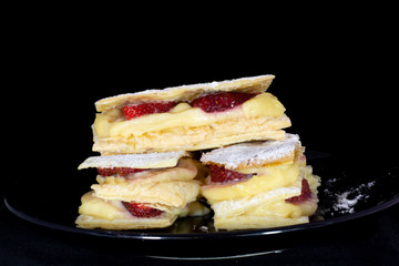 Russian napoleon cake with fresh strawberry with isolated black background