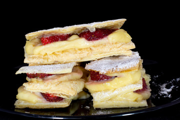 Russian napoleon cake with fresh strawberry with isolated black background