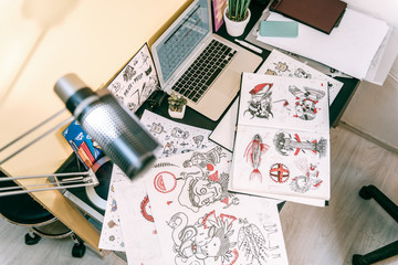 Black and white designs with red elements lying on the table