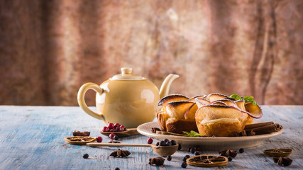 Crispy apple roses on color plate with several herbs and spices