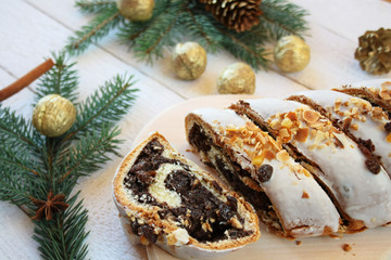 Poppy seed cake surrounded by spruce branches and gilded nuts