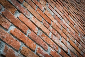 Red brick wall texture grunge background in perspective view. Selective focus