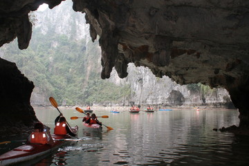 kayaker going through caves - Powered by Adobe