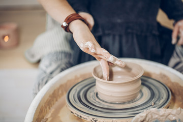 craft creation of children. child doing a clay project. close up cropped photo.