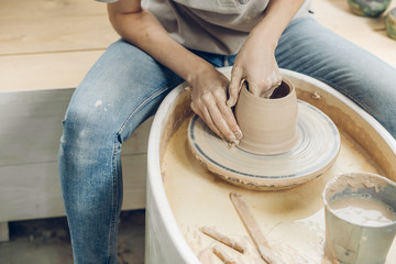 woman's hands on a potter. close up cropped photo,free time, hobby, lifestyle concept