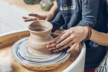 Fototapeta na wymiar ids arms making a bowl. close up cropped photo.hand pot. handcraft pottery