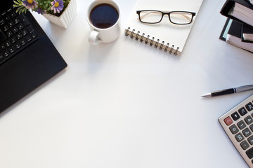 Business table with laptop and coffee. top view.