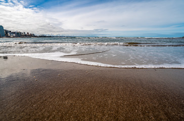 Fototapeta na wymiar waves of the Atlantic Ocean rolling on the sand