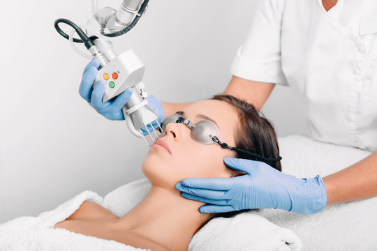 woman getting laser facial treatment, aesthetic surgery,