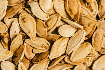 Macro look of roasted pumpkin seeds, flat lay