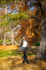 Photographing a girl during autumn with a blurred background