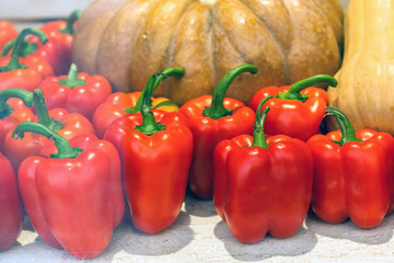 Heap of red peppers among the melons