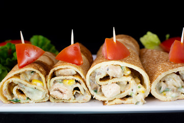 Chicken pancake with salad inside with isolated black background