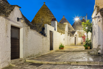 night alone street with trulli houses in Alberobello in Puglia in Italy