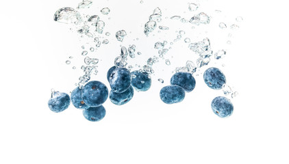 Blueberry’s splashing into crystal clear water with air bubbles