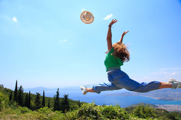 Female jumping in the air throwing her hat