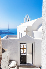 View of the entrance of a white Chapel in Fira, Santorini, Greece