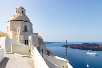 Fototapeta na wymiar View of small chapel and cruise ship at santorini, greece