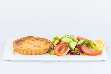 Spinach pie served with fresh salad with isolated white background