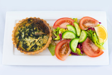 Spinach pie served with fresh salad with isolated white background