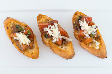 Delicious bruschetta with tomato and cheese with isolated white background