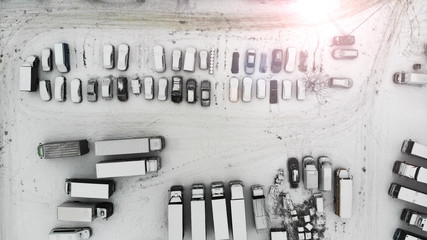 Parking lot with cars and trucks. Winter weather. Aerial.