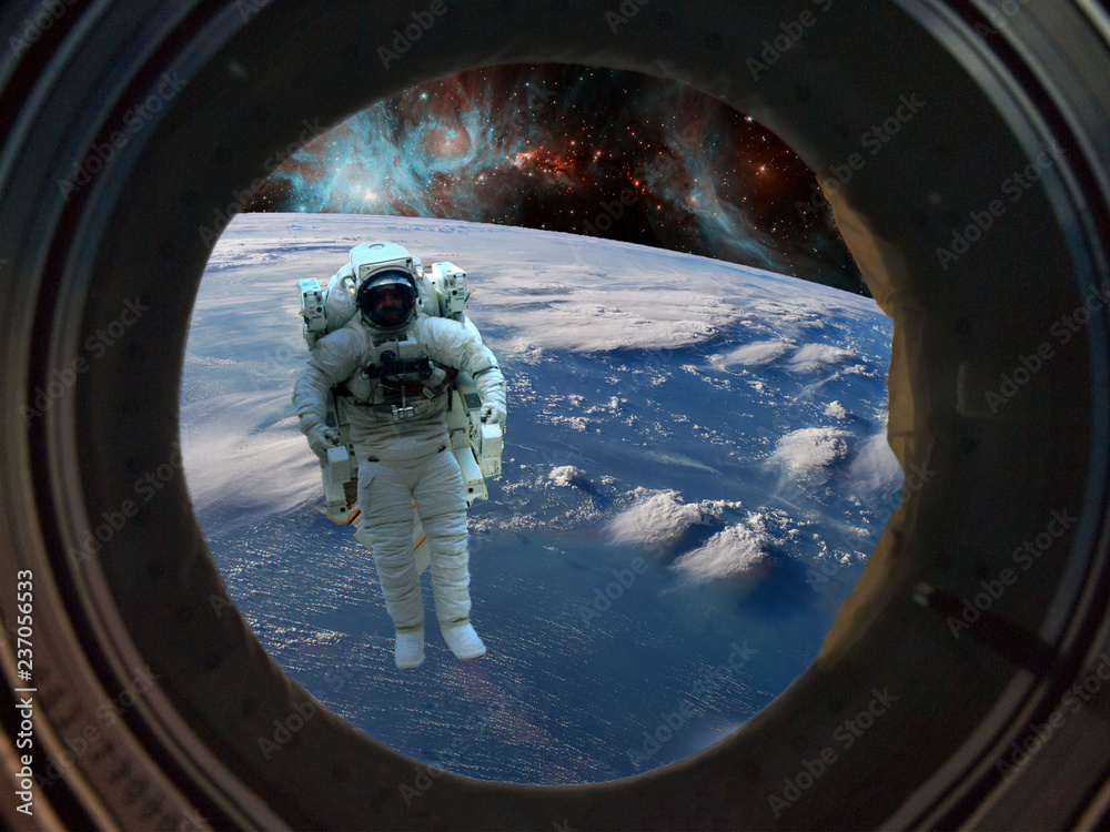 Canvas Prints astronaut spacewalk near the earth. view from the space ship illuminator. elements of this image fur