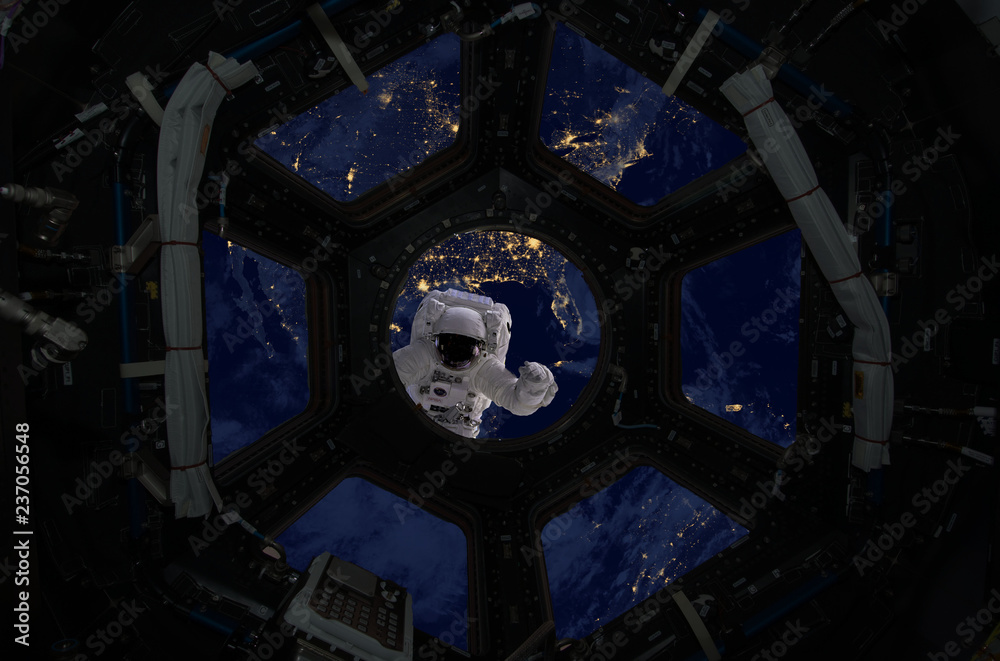 Canvas Prints astronaut spacewalk near the earth. view from the space ship illuminator. elements of this image fur
