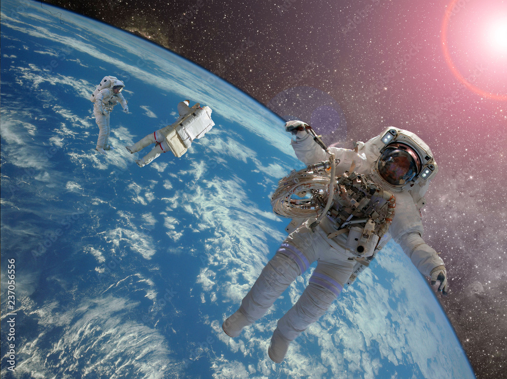 Poster astrounaut spacewalk in the space on earth orbit at night. elements of this image furnished by nasa 
