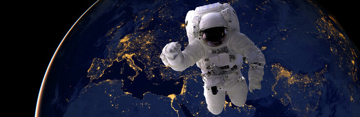 astronaut spacewalk at night from the dark side of the earth planet. Elements of this image...