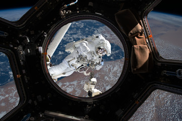 astronaut spacewalk near the earth. view from the space ship illuminator. Elements of this image furnished by NASA f