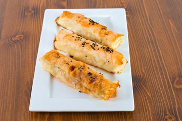 Delicious cheese pastry with black seed on top served on wood table